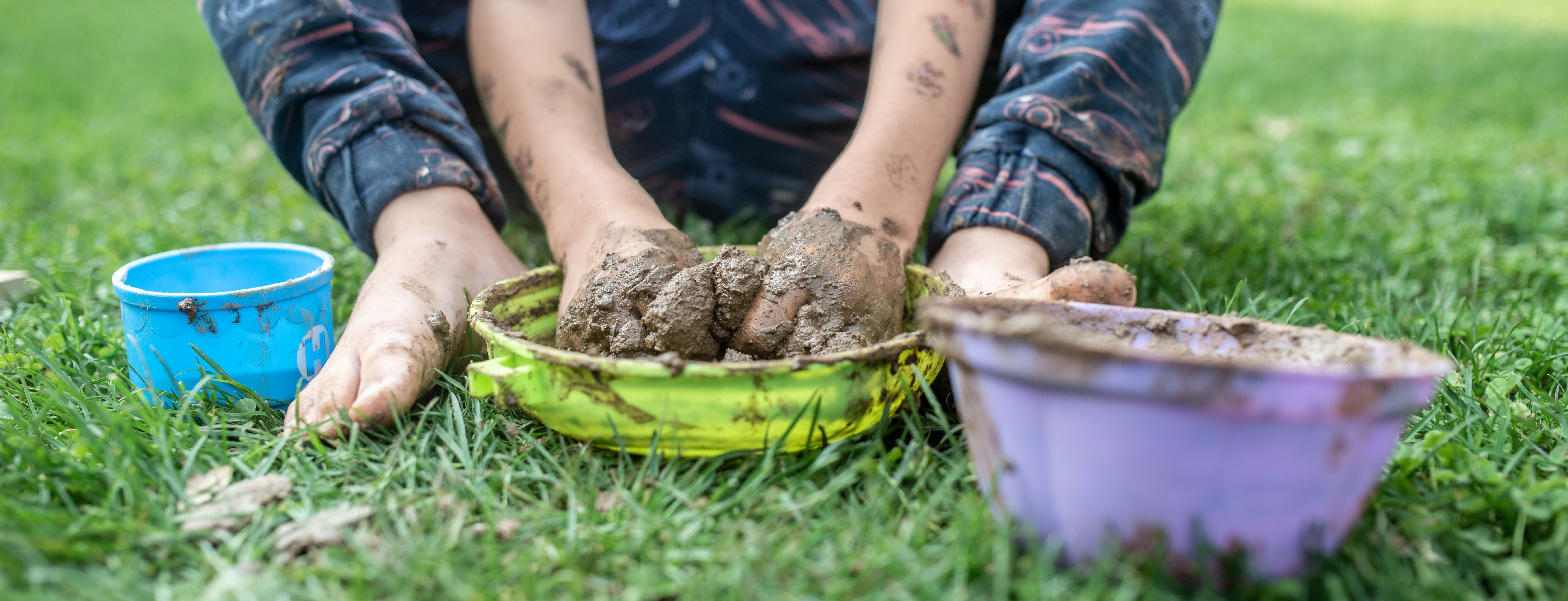 Child's hands playing with mud