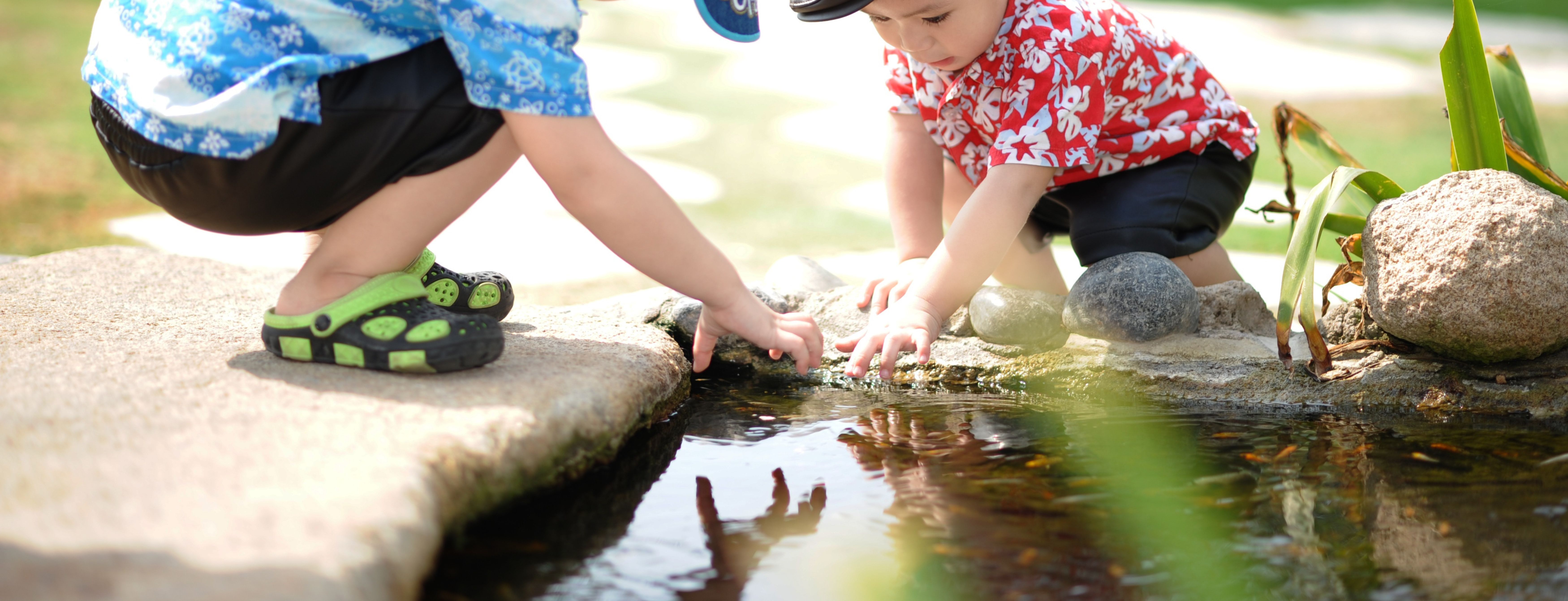 Children discovering a pond/pool of water