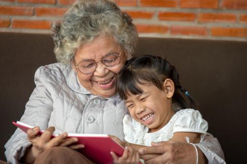 Grandmother reading to child for National Storytelling Week 