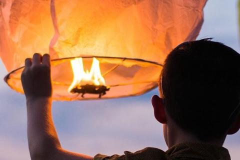 boy holding lantern cropped image