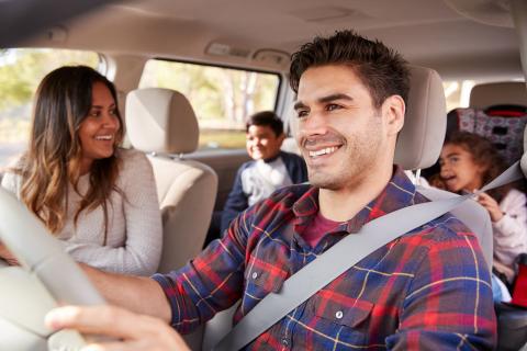 Family enjoying a car journey together