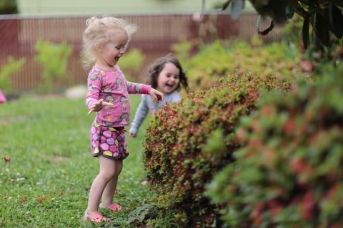 Little girls in the garden by Parker Knight