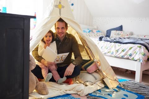 Father and child in an indoor den