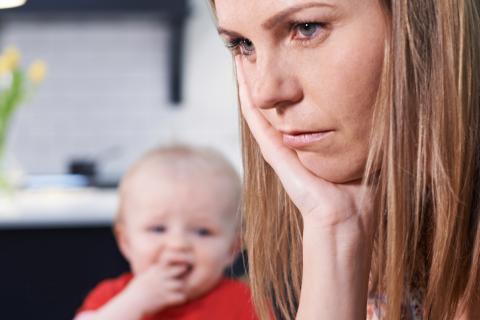 Bored mum trying to feed her child