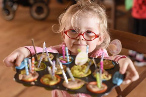 Girl in glasses offering buns