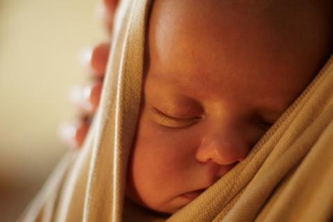 baby sleeps in a sling