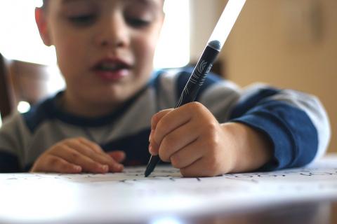 Boy writing with left hand