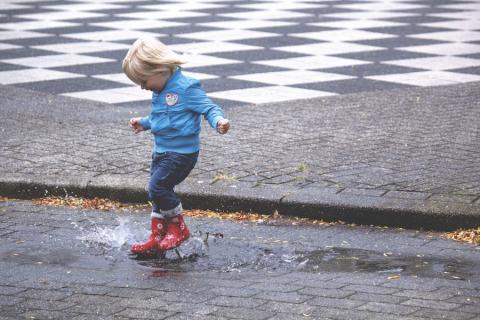 Boy splashing in puddles