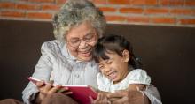 Grandmother reading to child for National Storytelling Week 