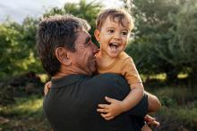 man and toddler laughing