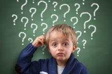 Boy scratching his head because of too many questions