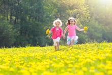 Children running through wildflowers