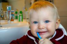 Baby brushing his teeth