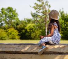 Girl sitting in the shade