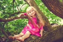 Happy girl in tree