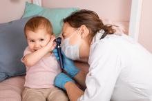 doctor looks in child's ear
