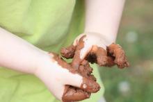 Child's muddy hands