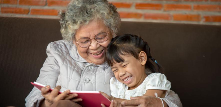 Grandmother reading to child for National Storytelling Week 