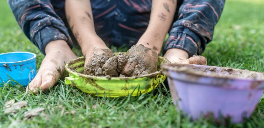 Child's hands playing with mud
