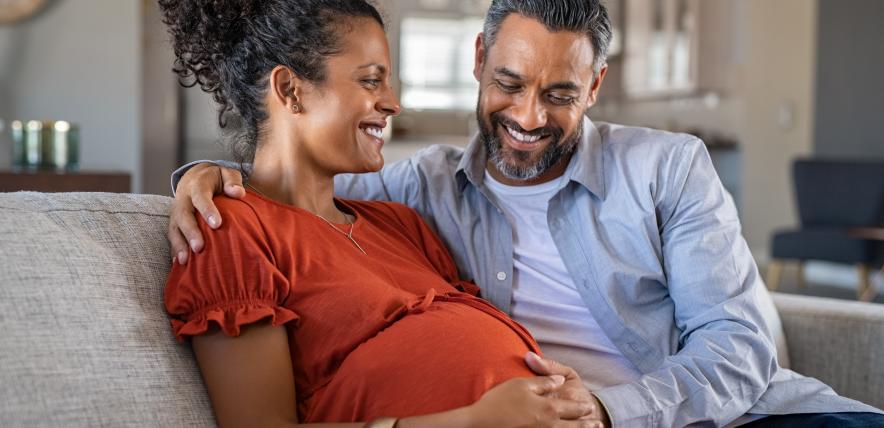 Woman with pregnancy bump and her partner