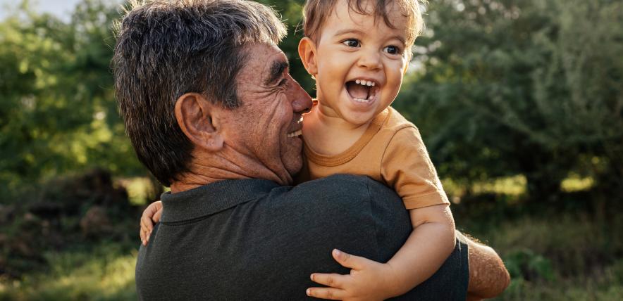 man and toddler laughing