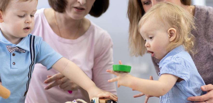 Children and women playing in nursery