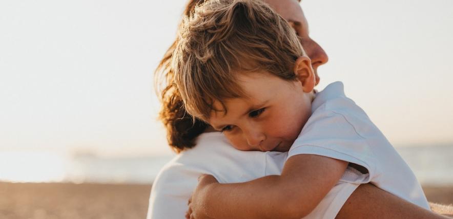 Boy and woman hugging