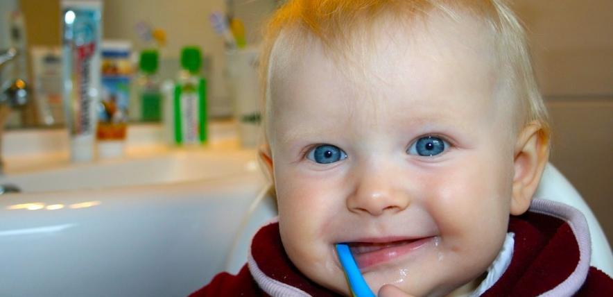 Baby brushing his teeth