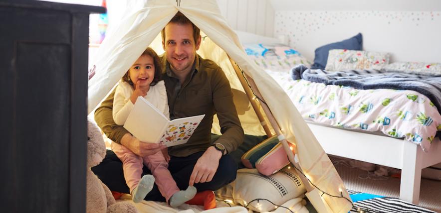 Father and child in an indoor den