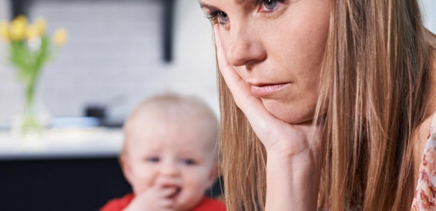 Bored mum trying to feed her child