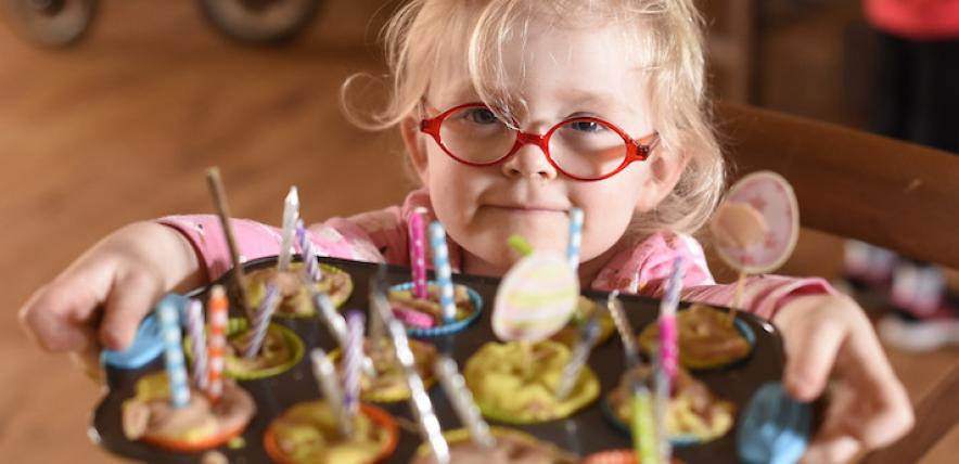 Girl in glasses offering buns