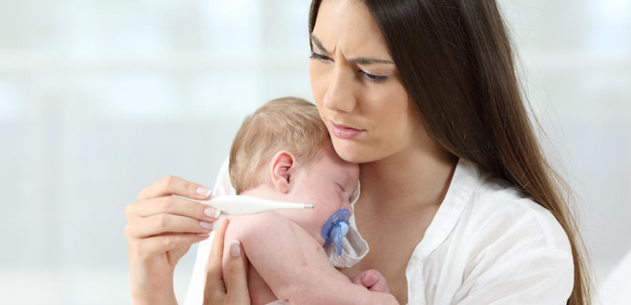 Mother checking baby's temperature