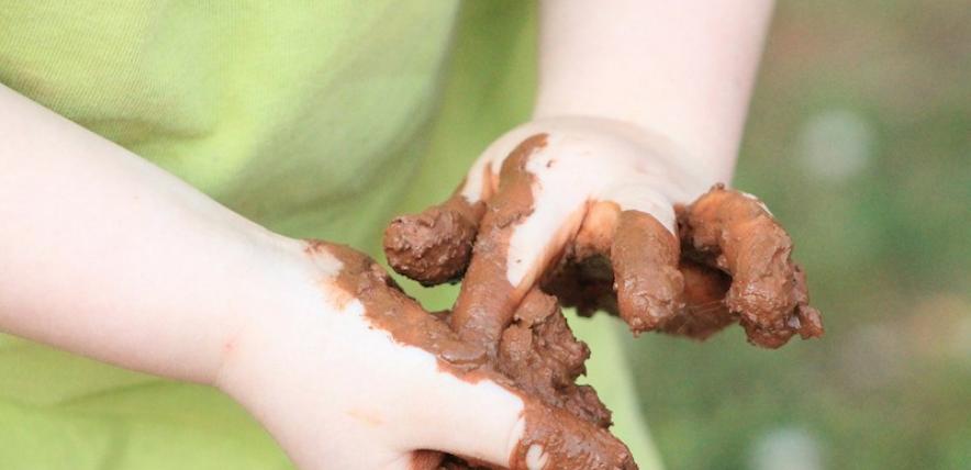 Child's muddy hands
