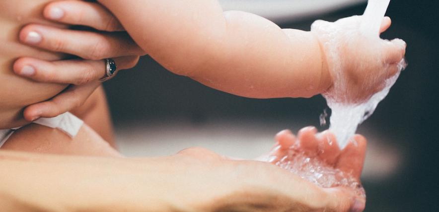 Parent and child washing their hands