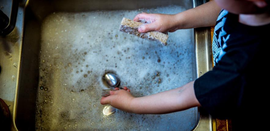 Boy washing dishes